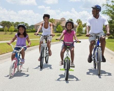 Family Riding Bikes in Neighborhood Family Riding Bikes in Neighborhood